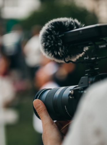 A selective of a camera in the hand of a photographer